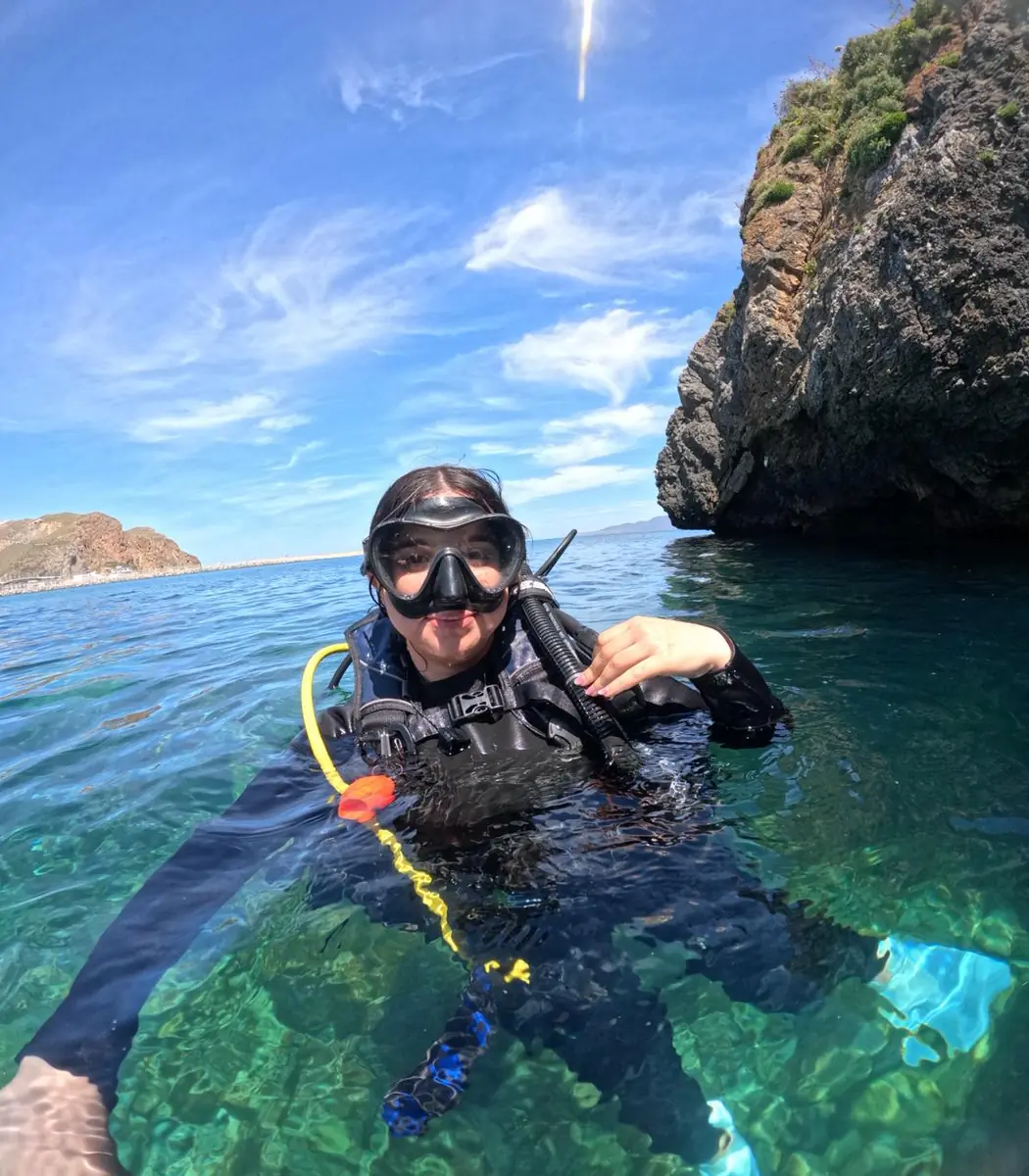 Diver in clear water near Al-Hoceima cliffs
